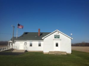 Newark Town Hall with American flag, clear sky.