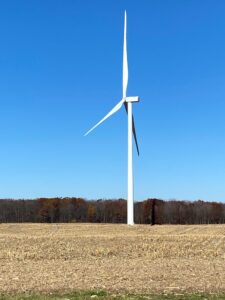 Wind turbine on a clear day in a field.
